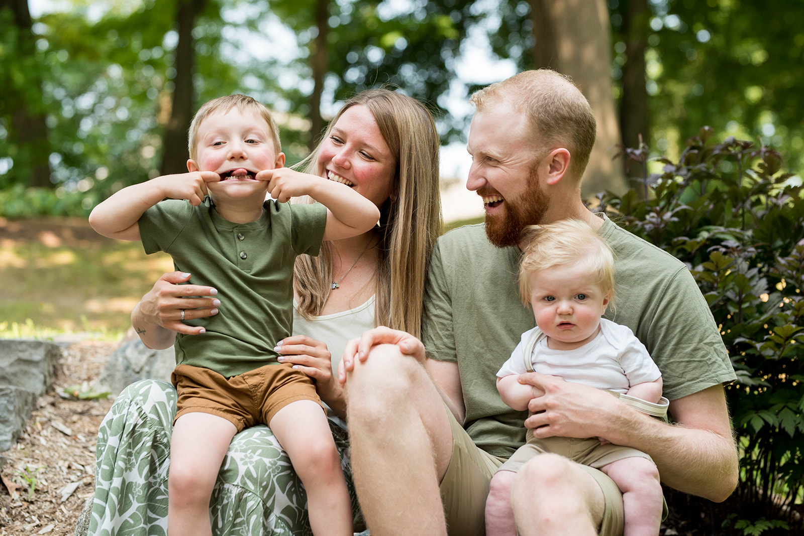 Family sitting together outdoors laughing in the Eastern Townships, Quebec