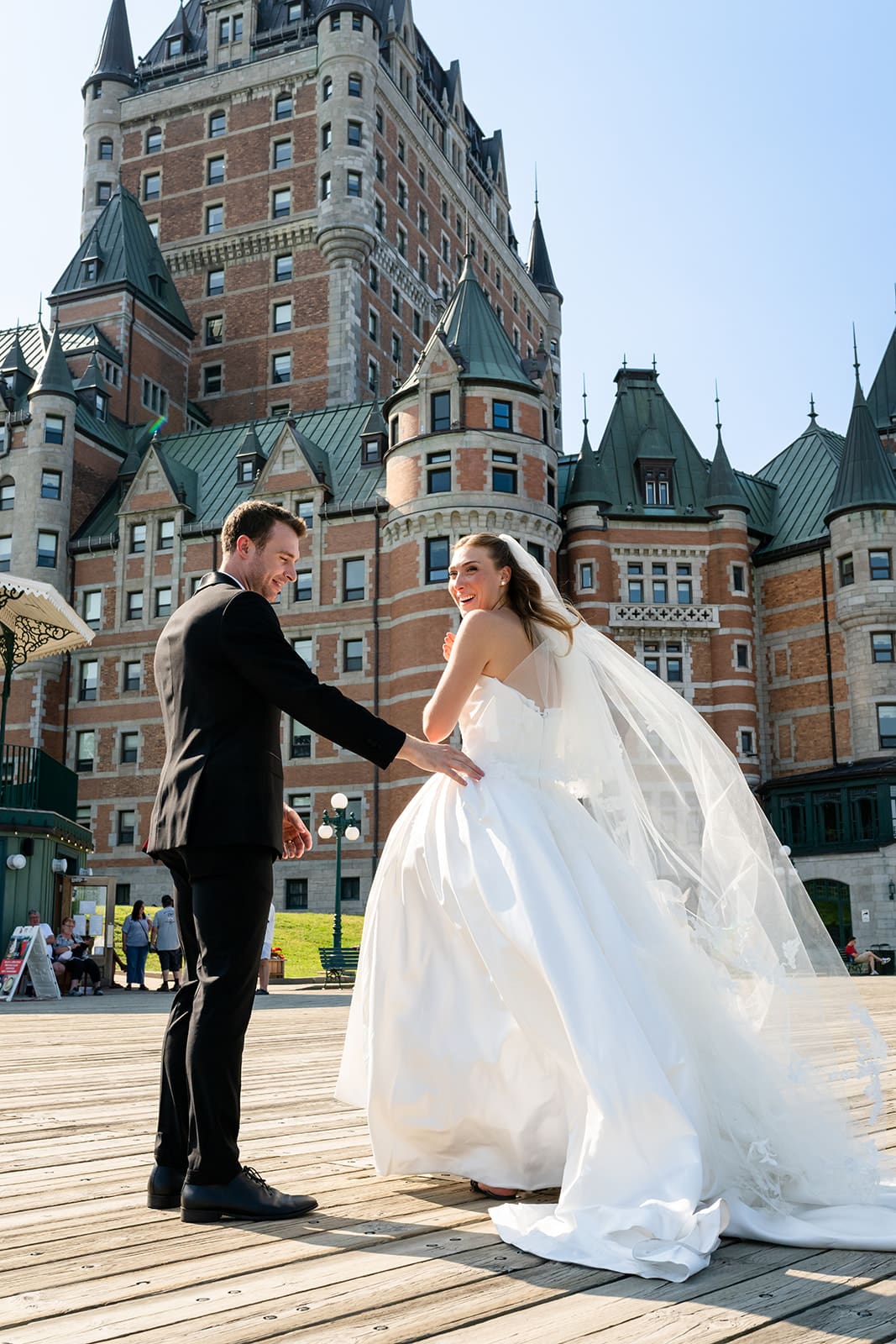 Bride and groom together in front of Fairmont Le Château Frontenac in Québec City